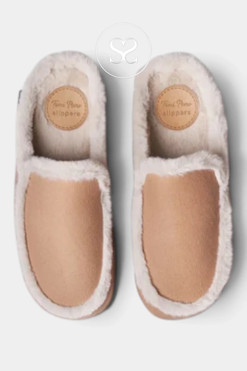 A pair of slip-on slippers with a soft beige suede-like footbed and fluffy cream faux-fur trim, shown from a top-down view on a light gray background. The brand name 'Toni Pina slippers' is visible on the insole patch.
