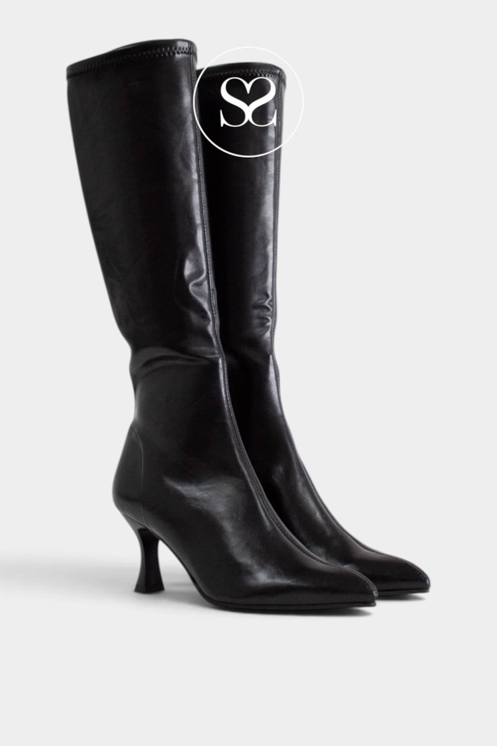 A pair of black knee-high leather look boots with a pointed toe and a short kitten heel, shown against a light grey background. A white circular logo overlay with the letters 'Sheneil shoes' is visible near the top of the boot.