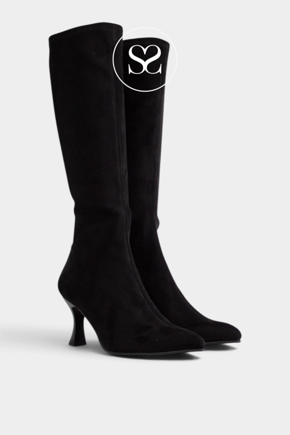 A pair of black suede Miss Elastic knee-high boots with kitten heels, shown from a side profile on a light grey background. A circular logo overlay with the letters 'Sheneil Shoes' is visible near the top of the boot.