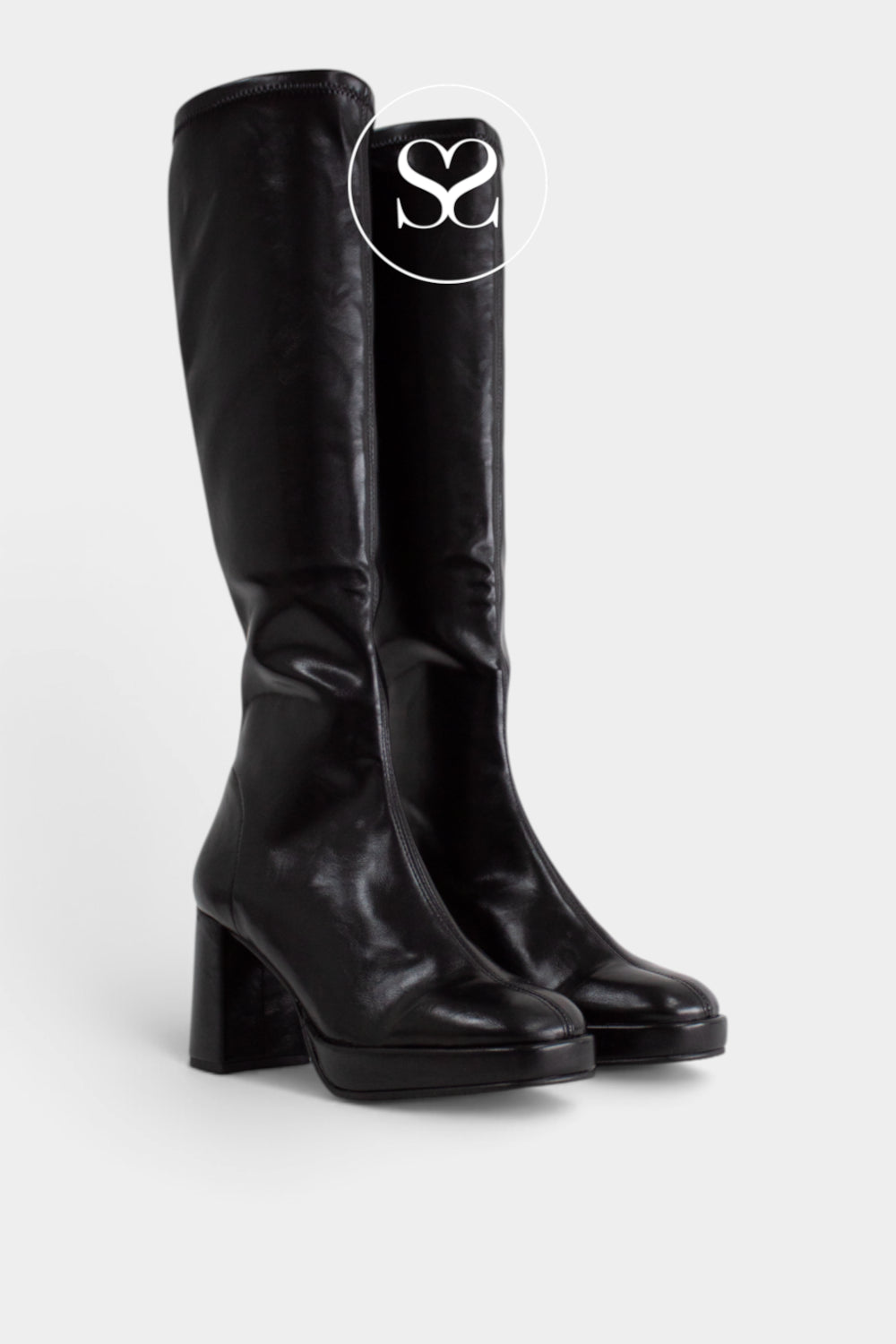 A pair of black leather knee-high boots with a chunky block heel and rounded toe, shown on a light gray background with a white circular 'Sheneil Shoes Ireland' logo overlay near the top.