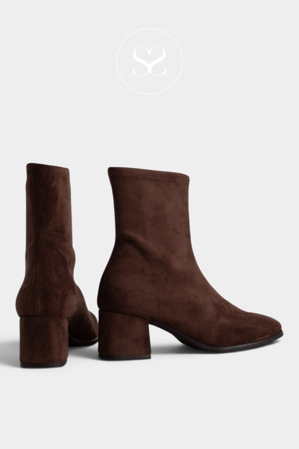A pair of Miss Elastic dark brown suede ankle boots with block heels, shown from the side and back on a light gray background.