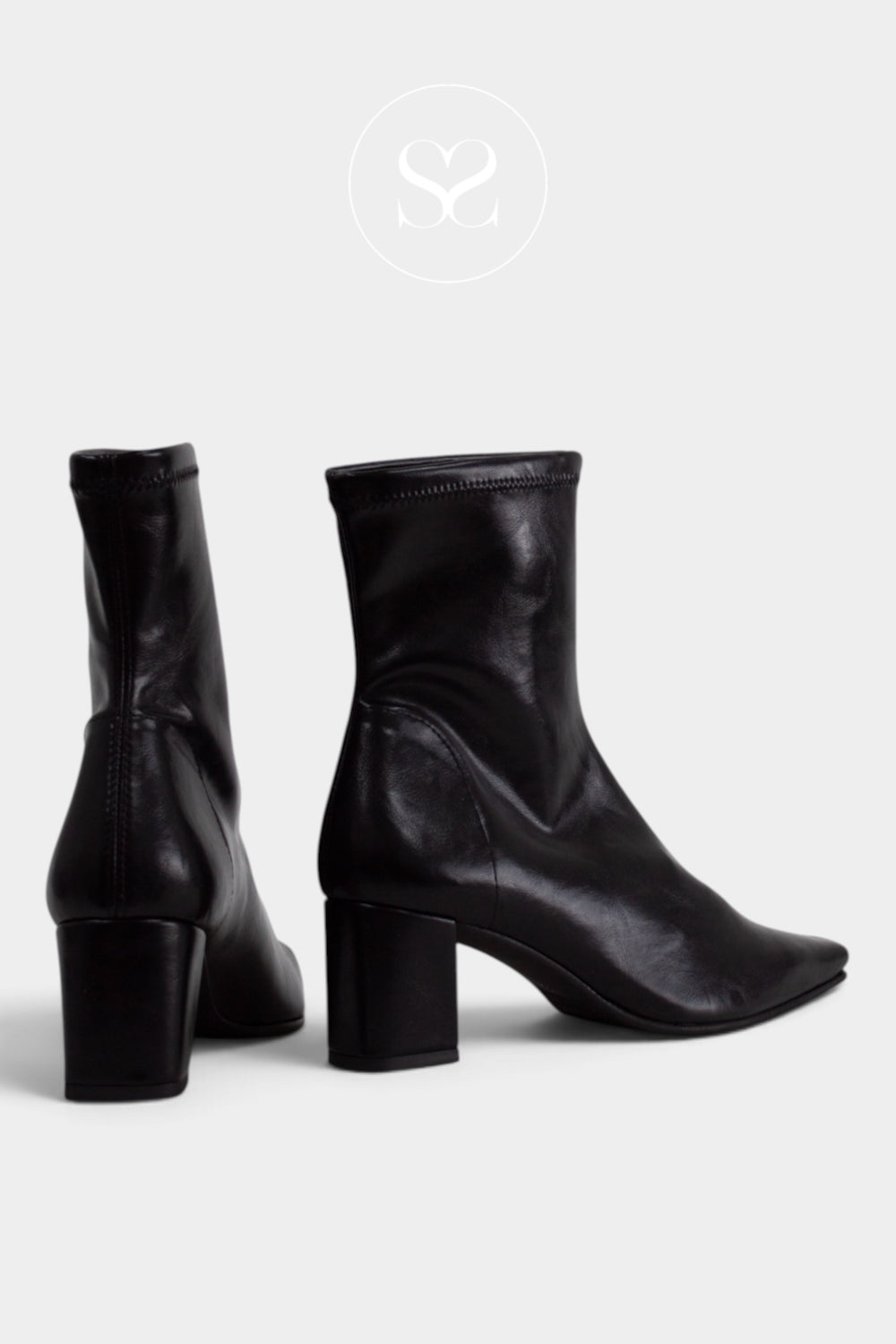 A pair of black leather ankle boots with block heels, shown from the side and back on a light grey background. From Miss Elastic in Ireland