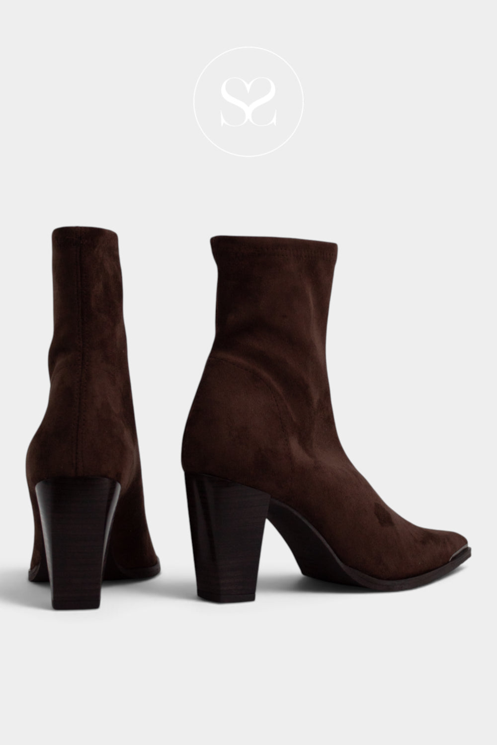 A pair of dark brown suede ankle boots with block heels from Miss Elastic shown from the side and back on a light gray background.