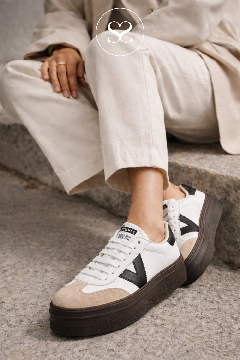 woman wearing white platfrom trainers from Spanish brand Victoria - Barcelona style with suede toe cap, brown sole and black v