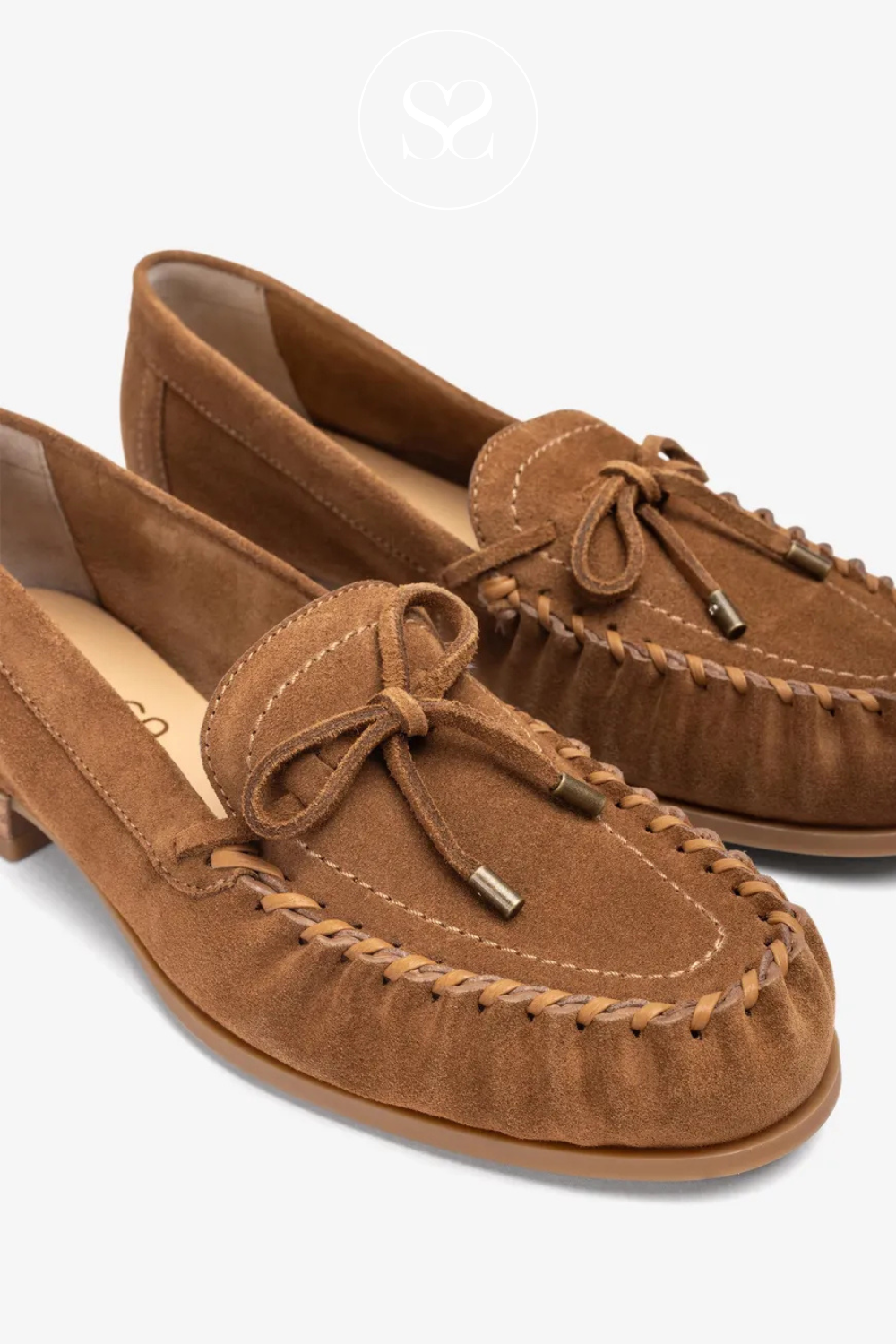 Pair of brown suede slip on loafers. Comfortable footbed. Twist and knotted round toe. Low block flat heel