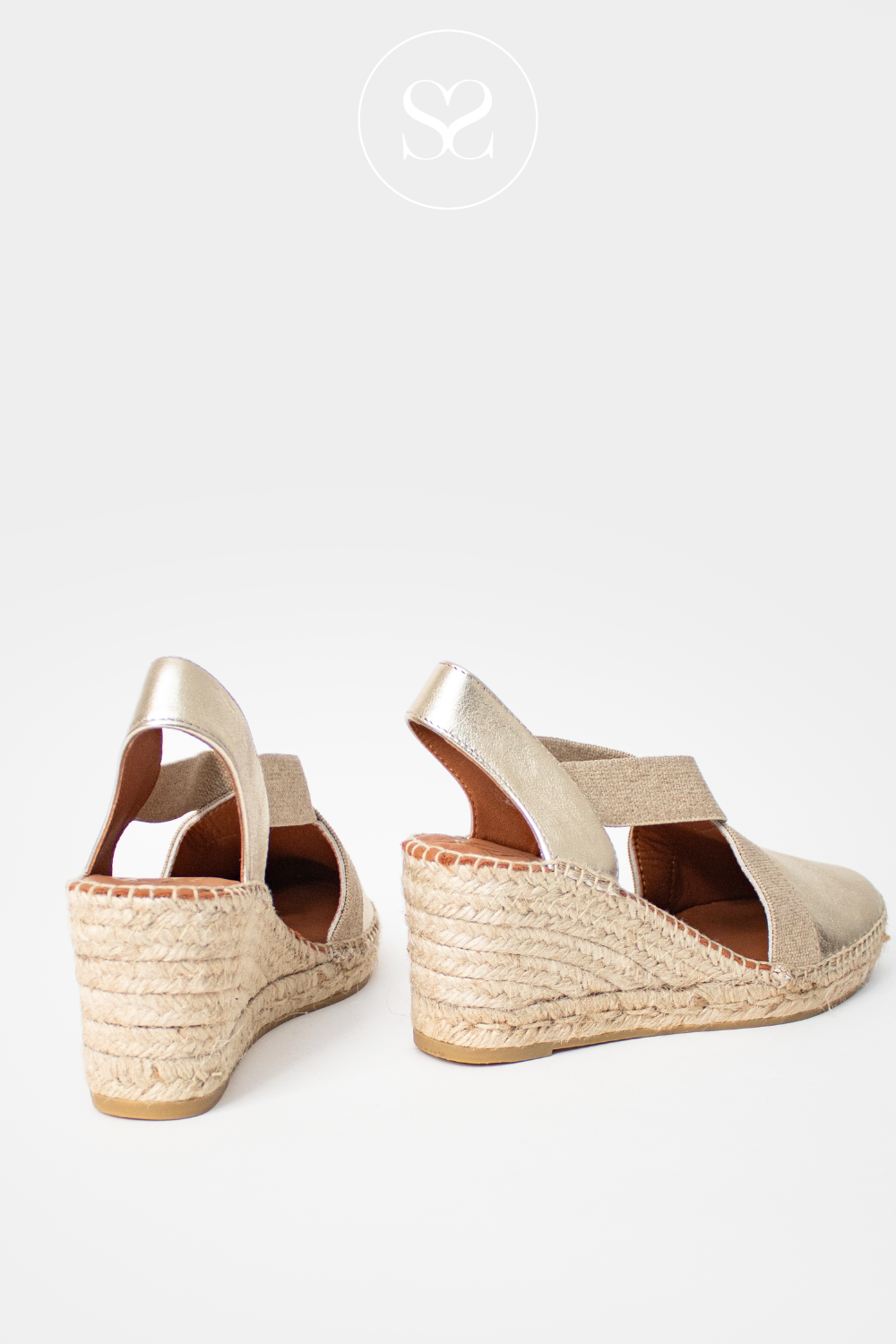 VIGUERA GOLD WEDGE ESPADRILLE SHOES. CLOSED TOE FRONT AND EXPOSED HEEL. SLIP ON SHOE WITH ELASTICATED CROSS FRONT.