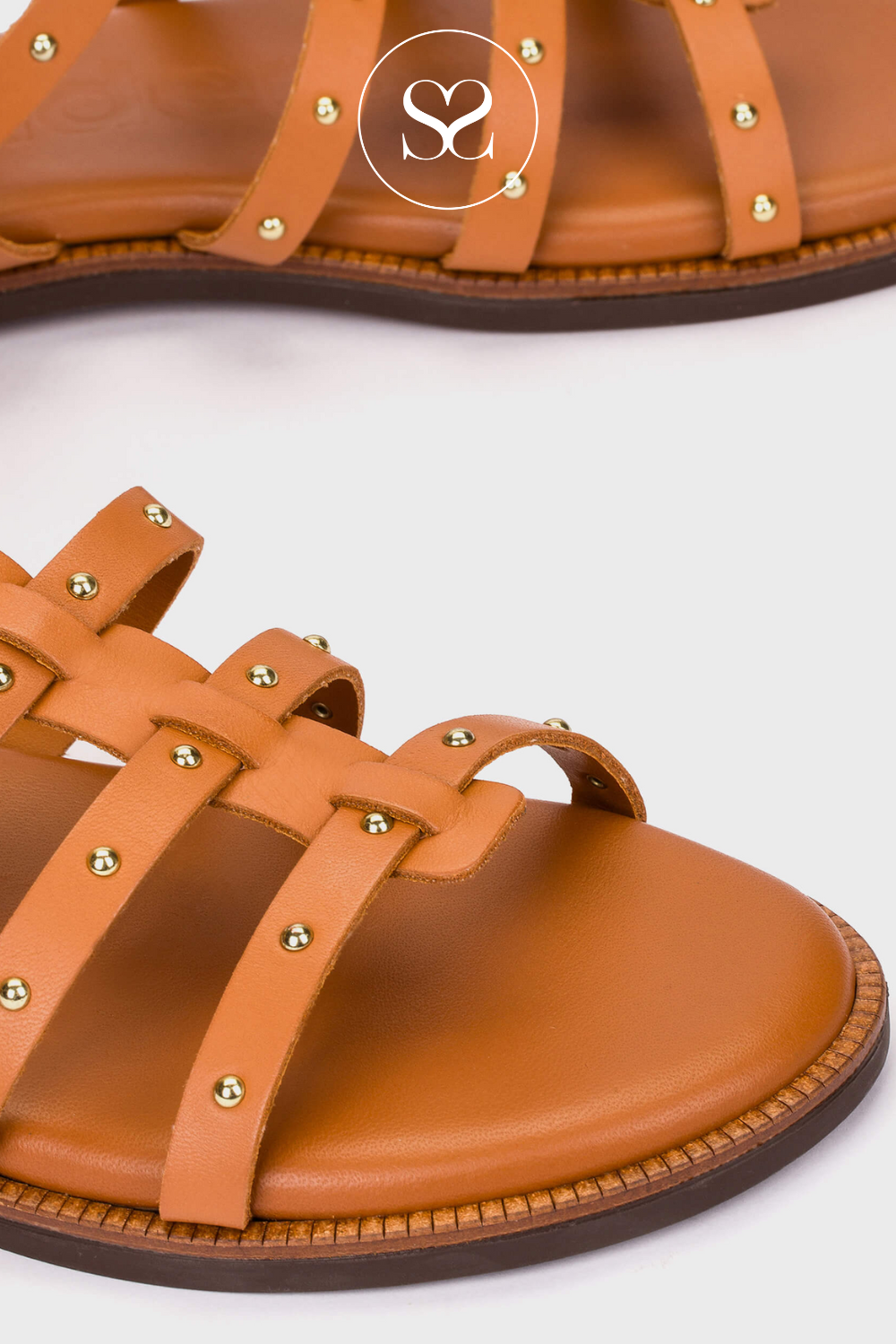 tan leather flat sandals by Wonders with adjustable ankle strap.