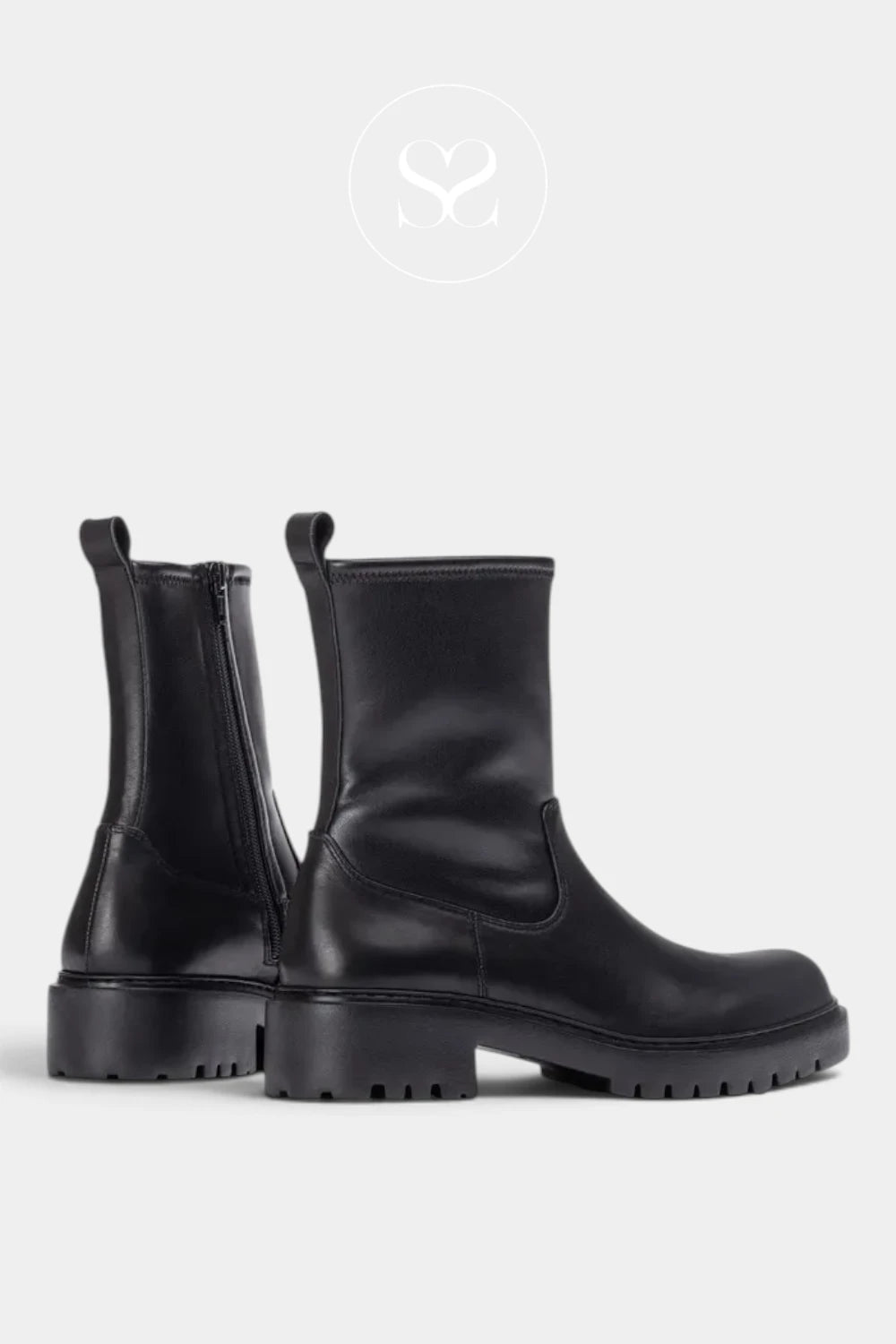 A pair of black leather Chelsea-style boots with side zippers and chunky lug soles, shown from the rear and side on a light gray background.
