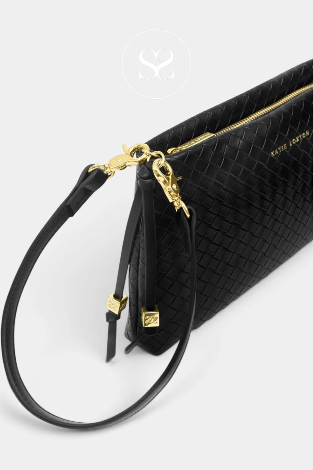 A close-up of a black woven leather clutch bag with a matching wristlet strap and gold-tone hardware, including a zipper and clasps.
