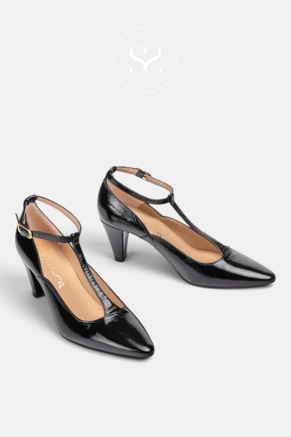 A pair of black patent leather slingback high heels with T-strap details and pointed toes, displayed on a light gray background with a brand logo above.
