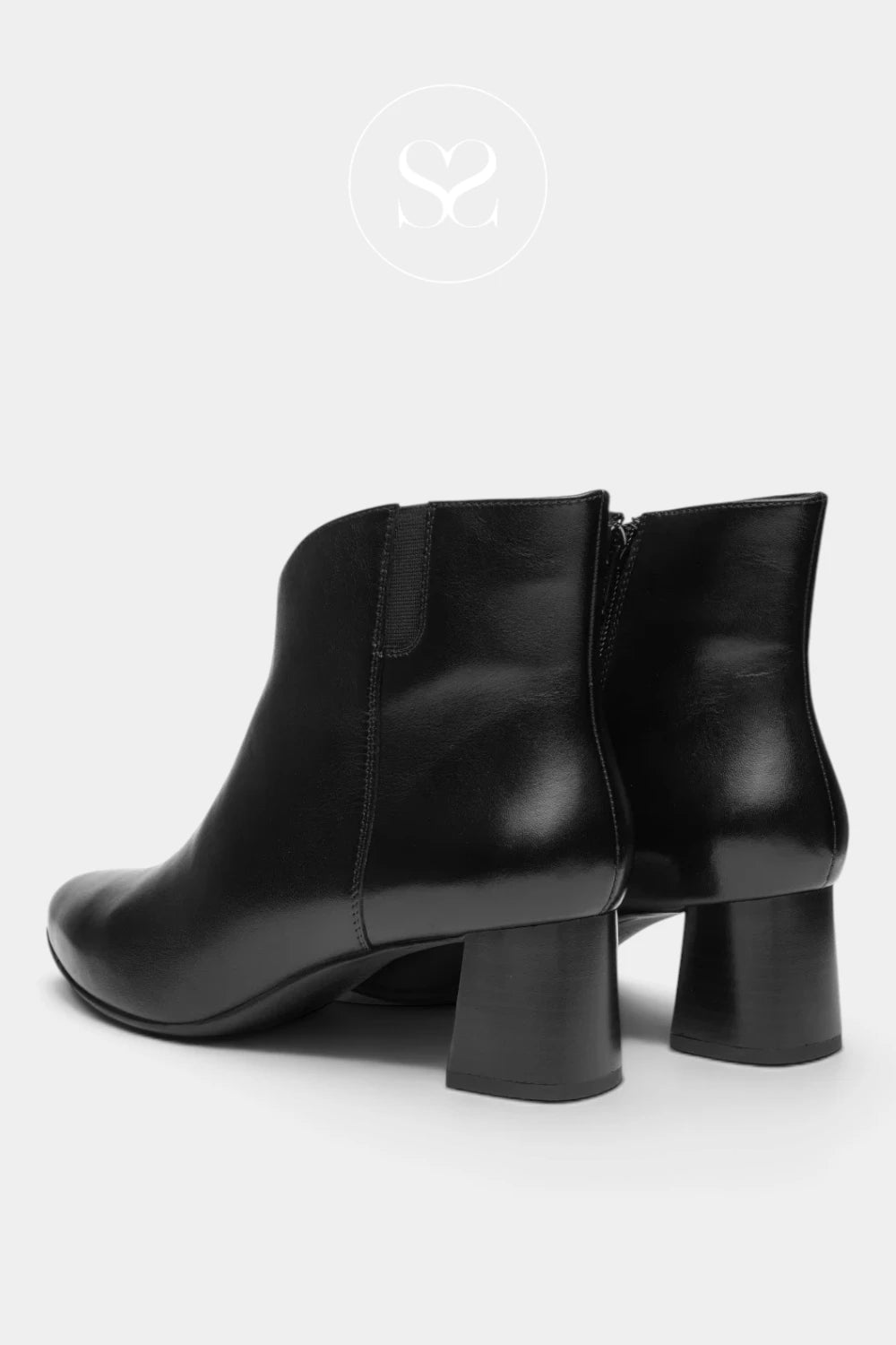 A pair of black leather ankle boots with block heels, shown from a rear three-quarter angle on a light gray background.