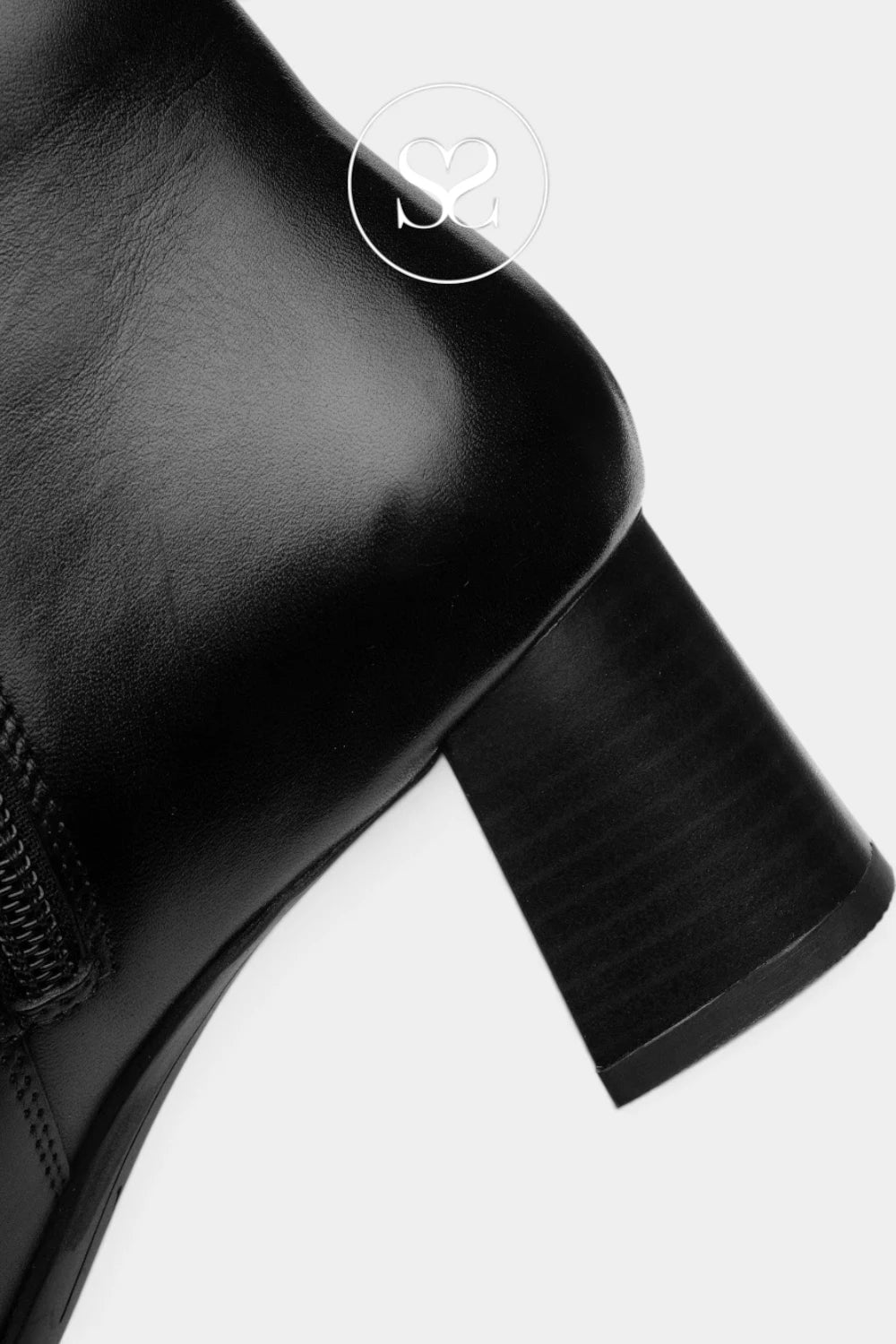 Close-up of a black leather ankle boot showing the side zipper, rounded toe, and block heel against a light gray background.