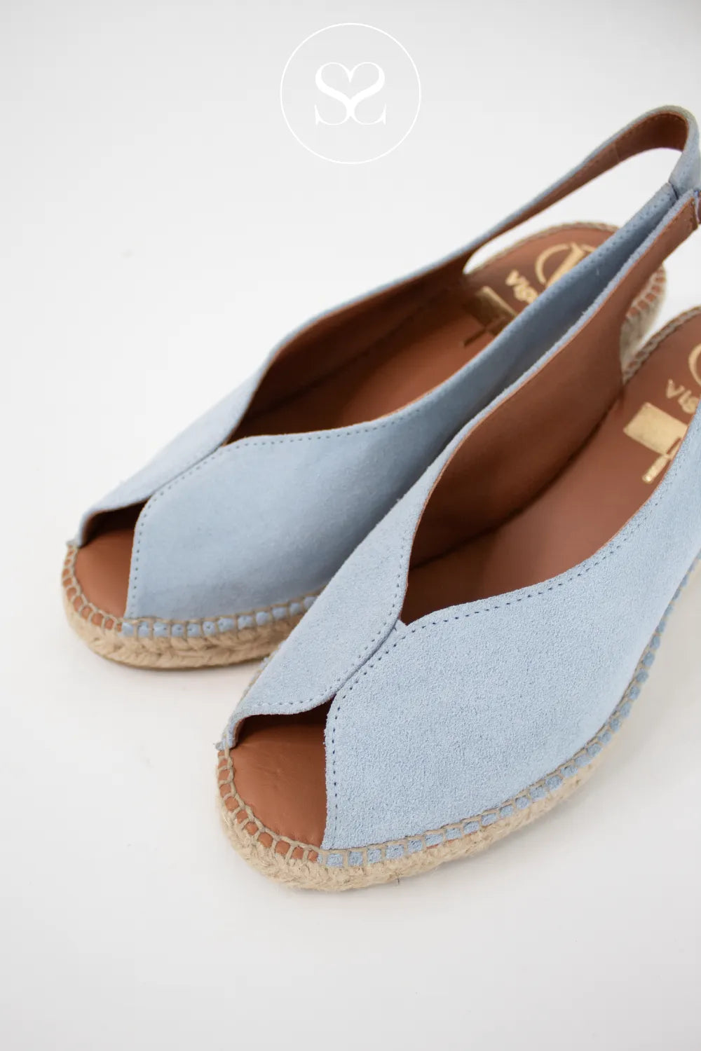 Light blue v-cut sandals with espadrille sole and elasticated slingback. Summer wedge sandals