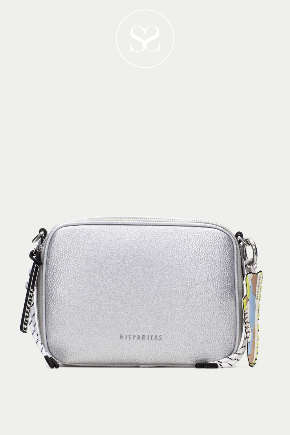 HISPANITAS silver crossbody bag with crossbody strap and one main zip pocket. Colourful trainer keyring. Metallic small leather bag