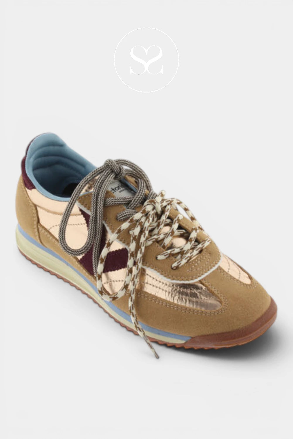 A low-top sneaker in tan suede and metallic gold leather with beige-and-white patterned laces, a blue interior lining, and a brown outsole, shown on a light gray background.