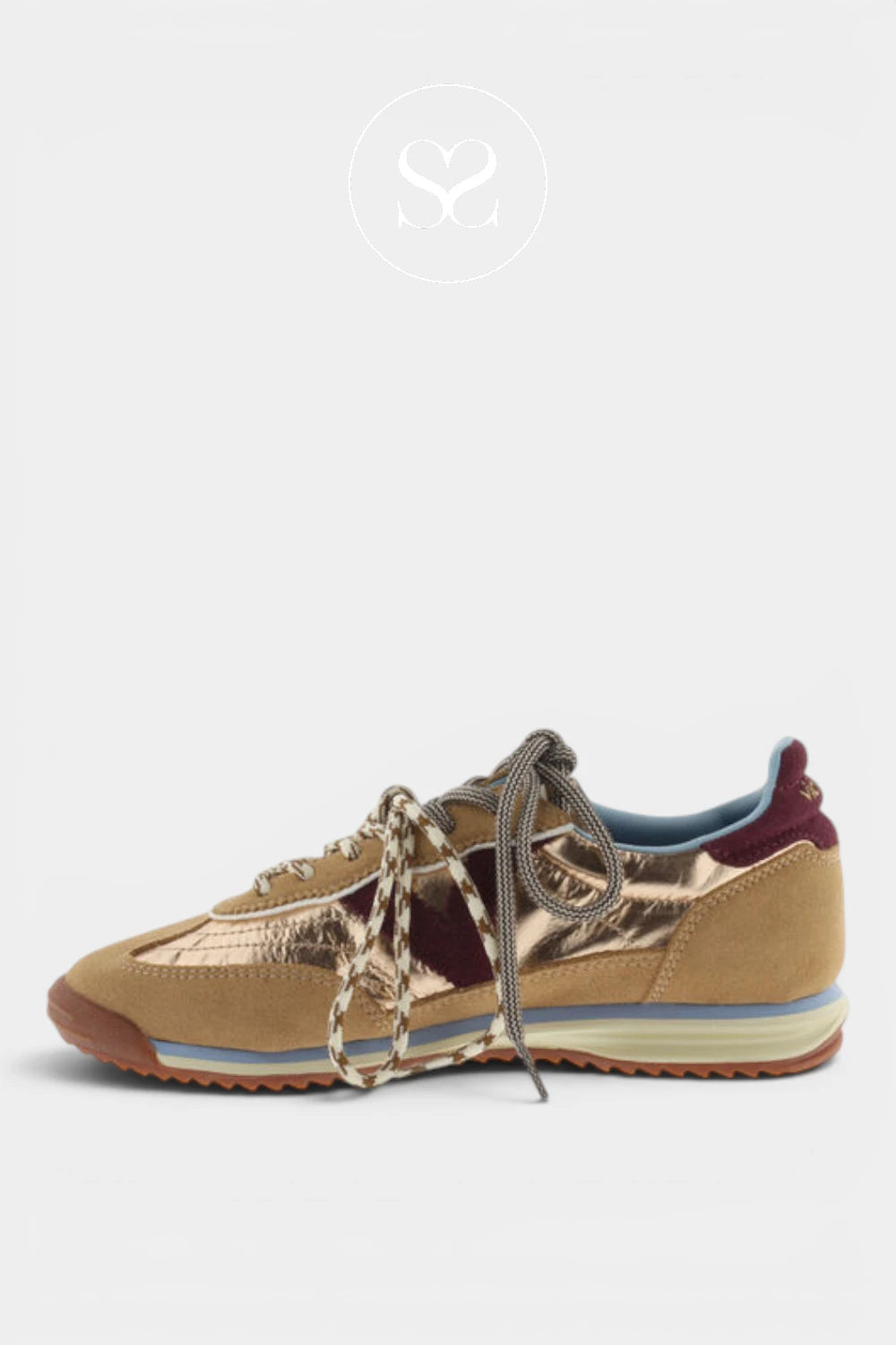 A low-top sneaker in metallic gold and burgundy suede with chunky braided laces, a light blue midsole stripe, and a brown gum outsole, shown against a light gray background.