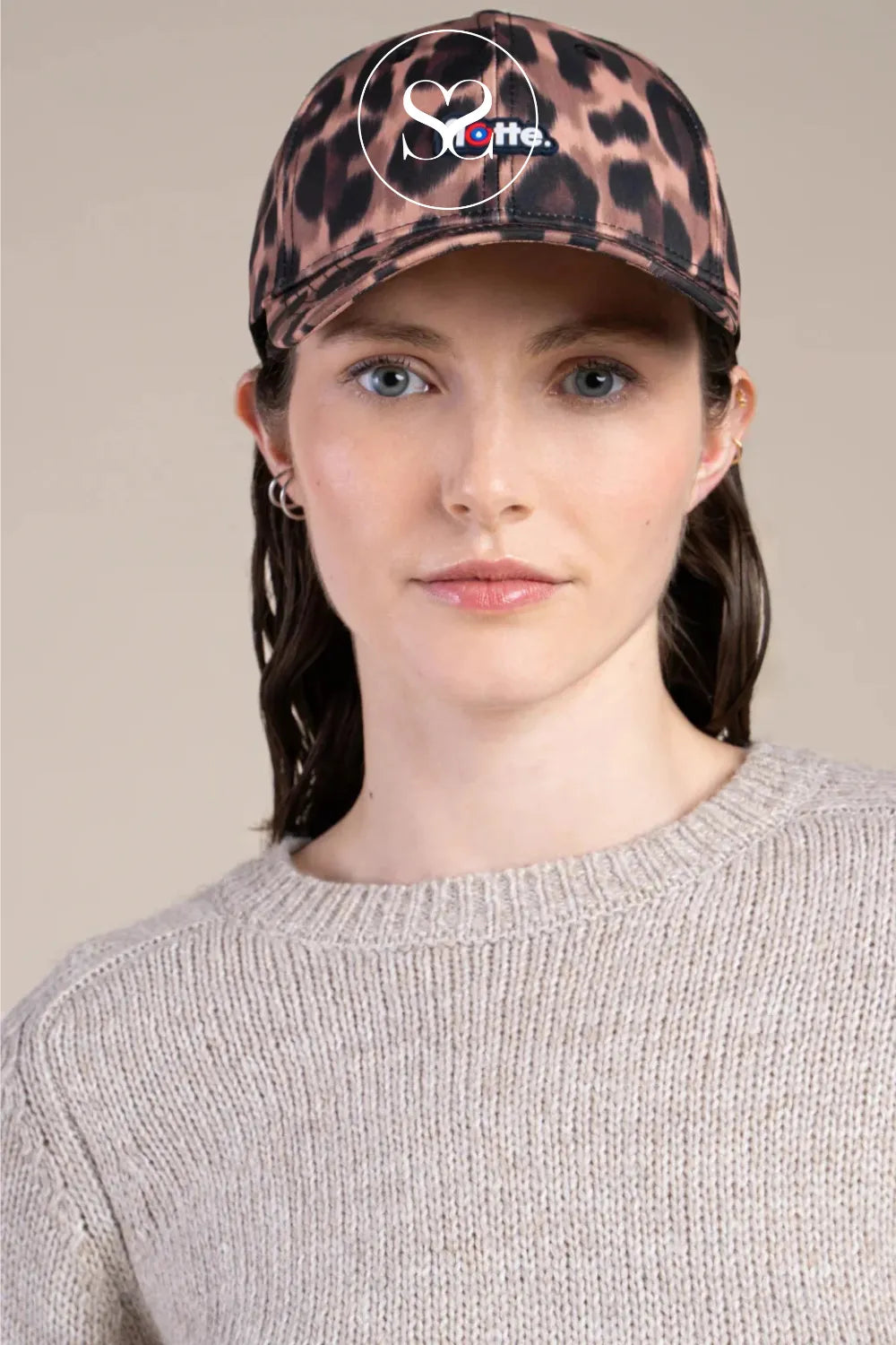 Flotte leopard print peaked cap with adjustable buckle. Water repellent hat