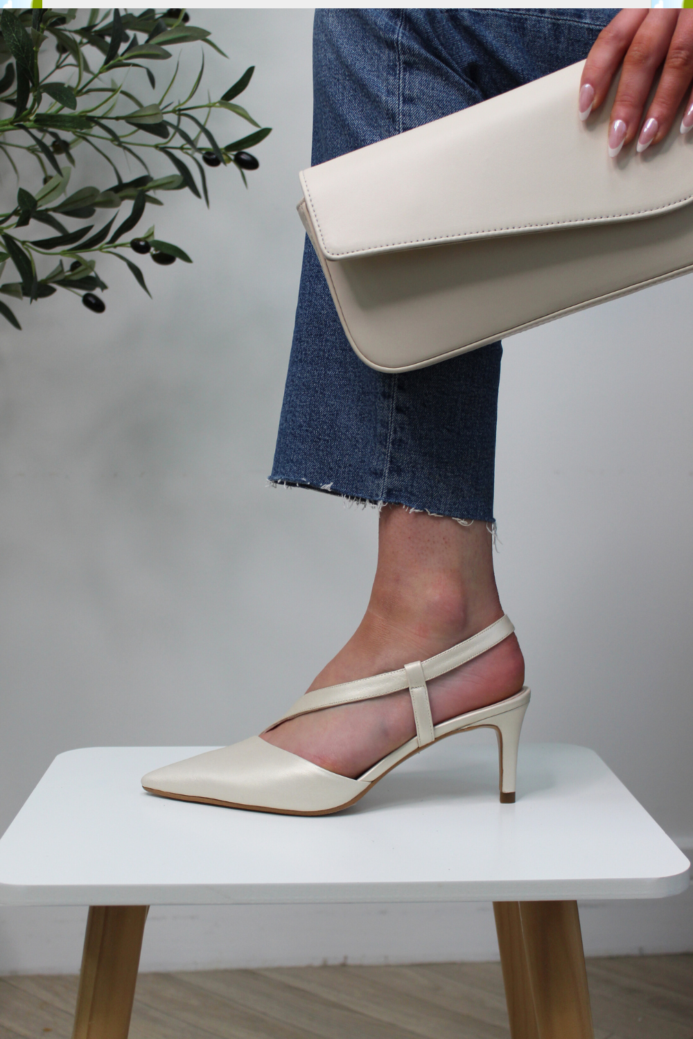 Lodi pointed toe high heels. Assymmetrical strap across foot and around ankle. No buckle. Cream champagne colour leather. 