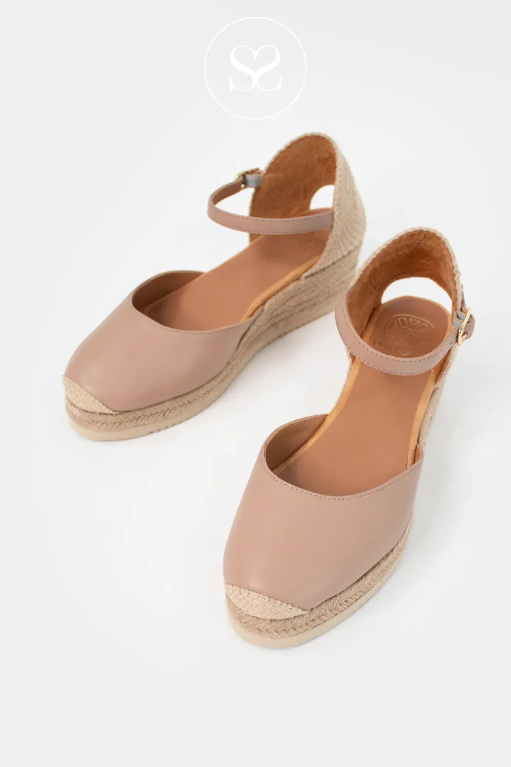 Unisa spanish leather espadrilles with ankle strap, round toe and espadrille sole. Cloth heel cap. Low wedge heel. Platform sole. Dressy wedge sandals.