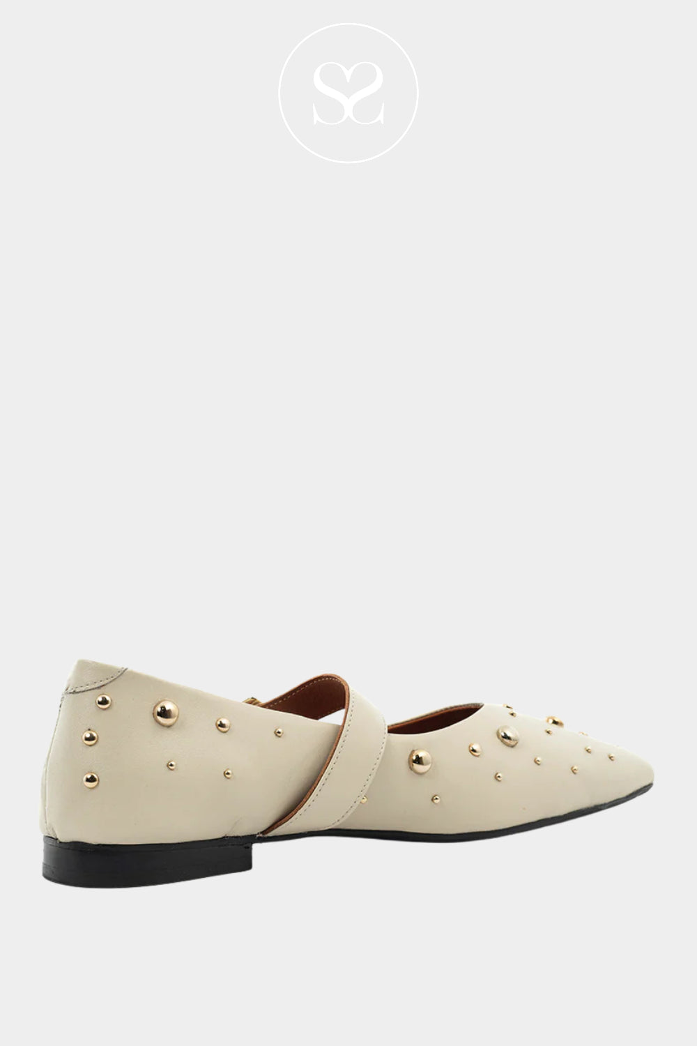 Pair of cream-colored mary jane pumps with gold studs