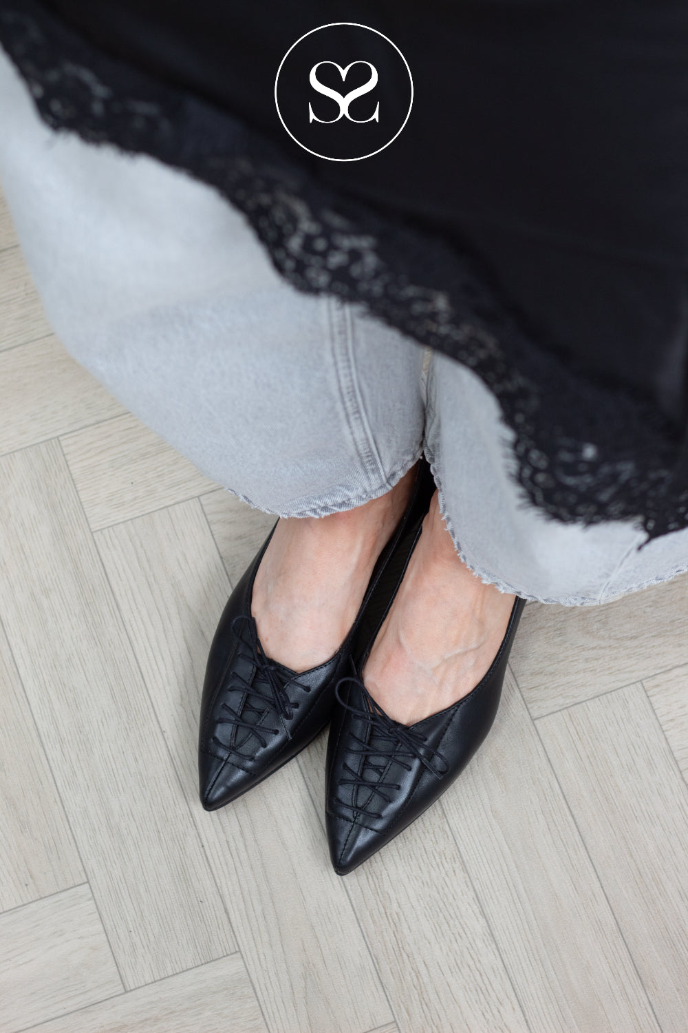 A pointed-toe block heel shoe in smooth black leather, built for the kind of days that move between desk and dinner without missing a beat. The 30mm block heel keeps things grounded while the lace detail to the front gives the silhouette a considered, modern edge