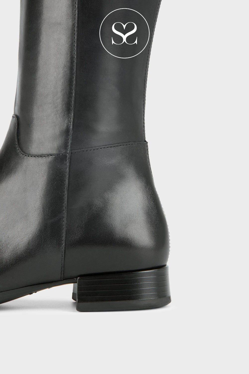 Close-up of a black leather boot Vagabond Monashowing the side profile, heel, and a circular white logo on the shaft against a light gray background.