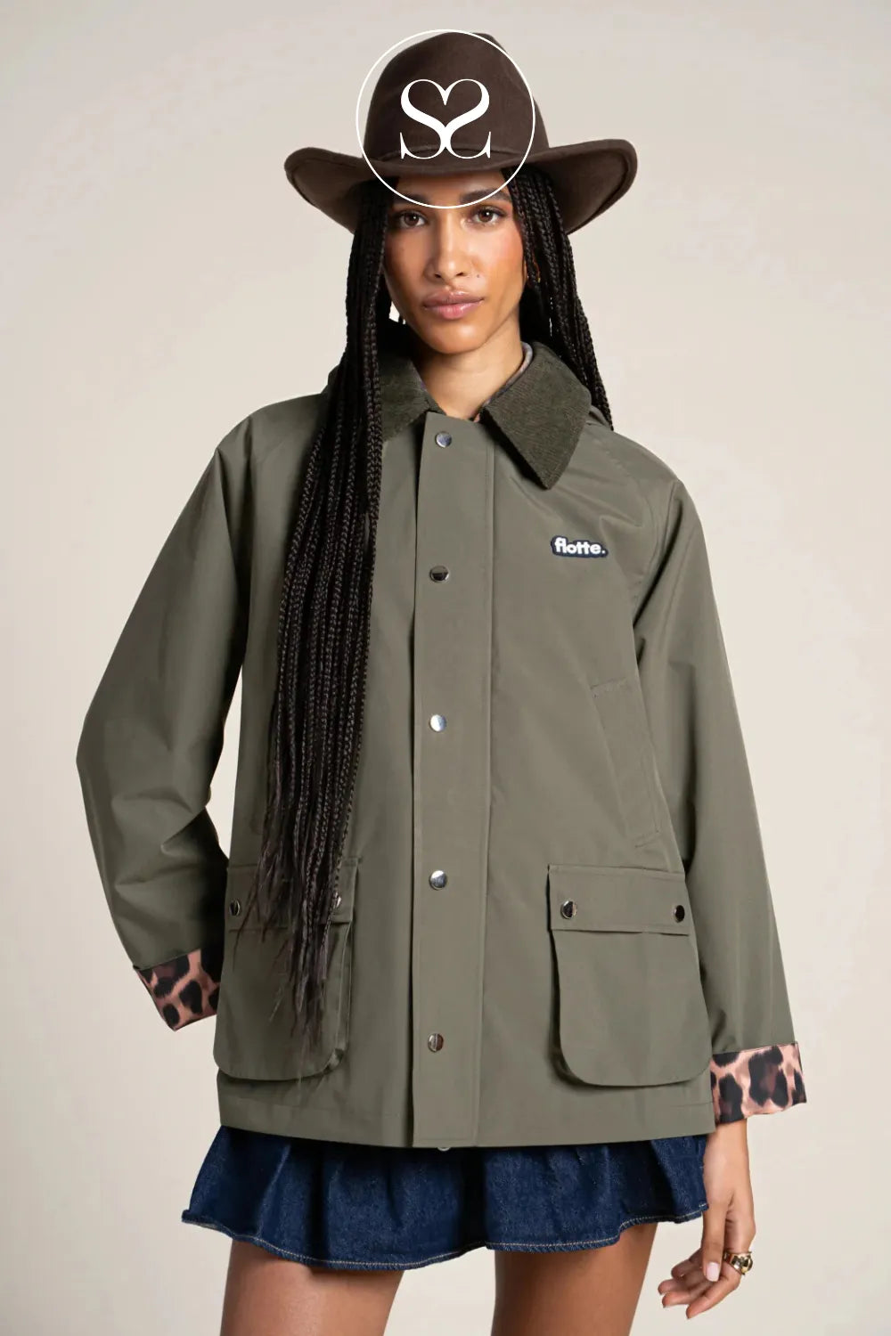 Waterproof khaki raincoat with detachable hood, turned up leopard print sleeves and pockets.