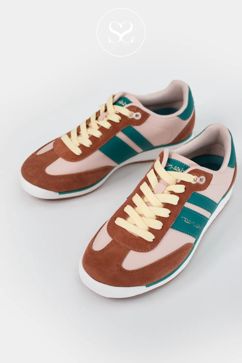 Pair of brown and pink sneakers with green stripes on a white background