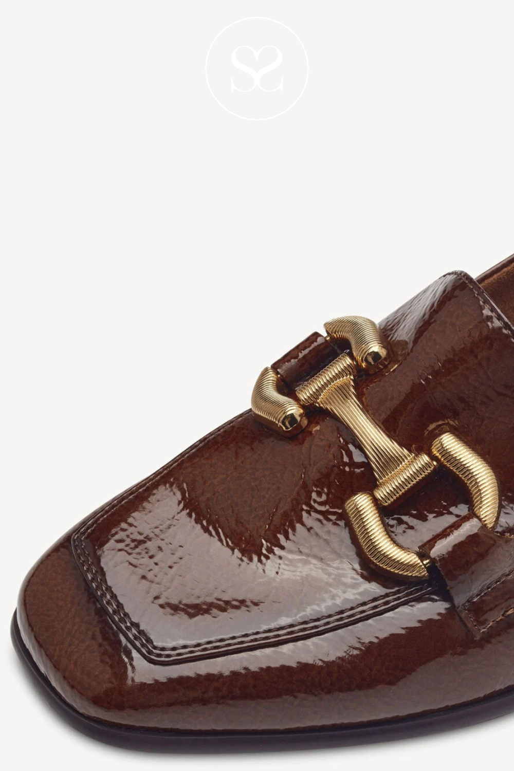 Square toe slip on loafers. Gold chain feature. Low block heels. Slip on shoes