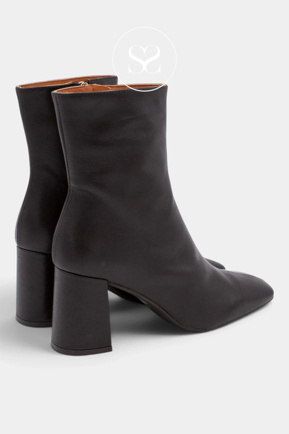 A pair of black leather ankle boots with block heels and pointed toes, shown from a three-quarters angle on a light gray background.