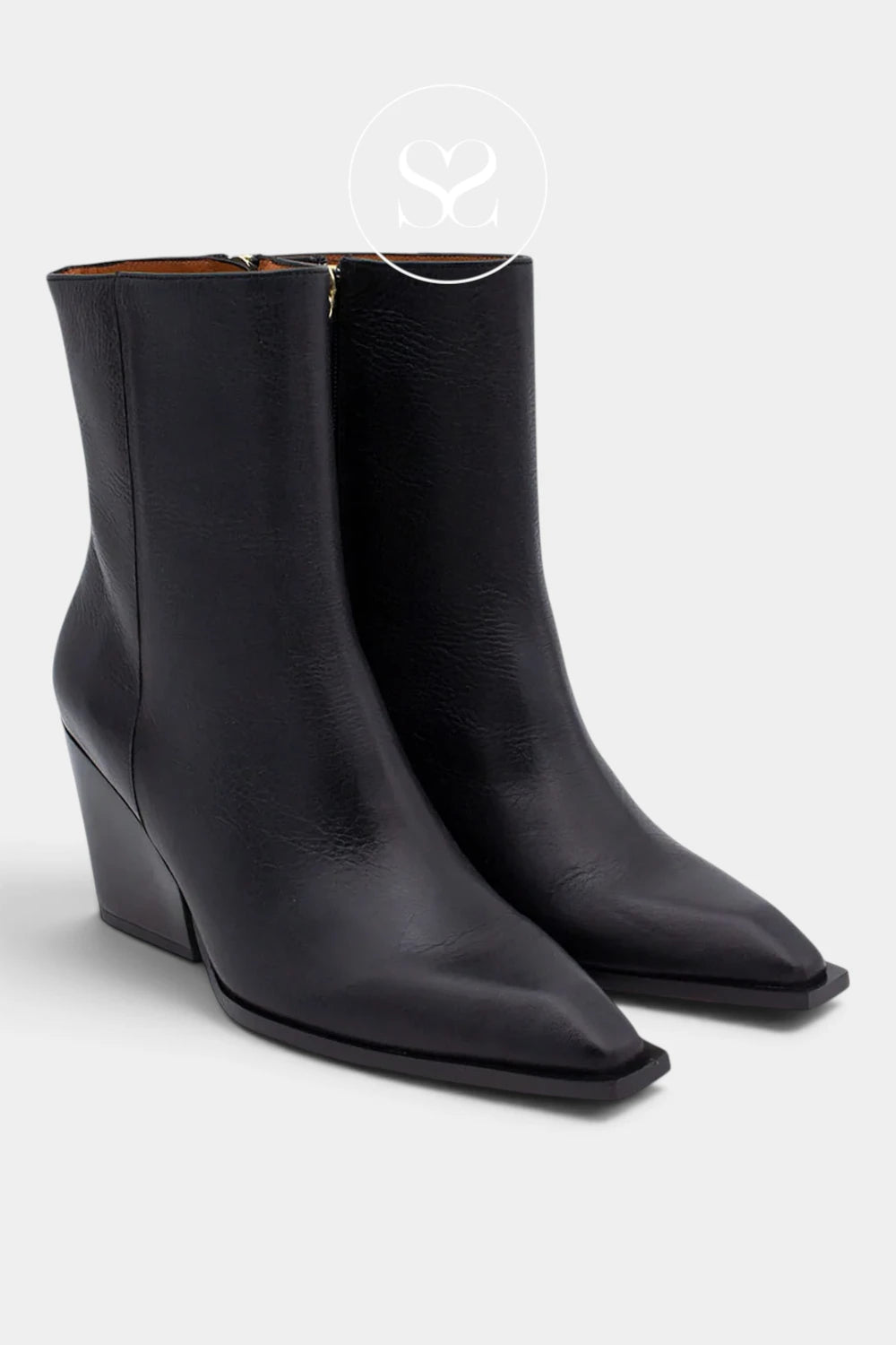A pair of black leather ankle boots with pointed toes and low wedge heels, shown on a light gray background.
