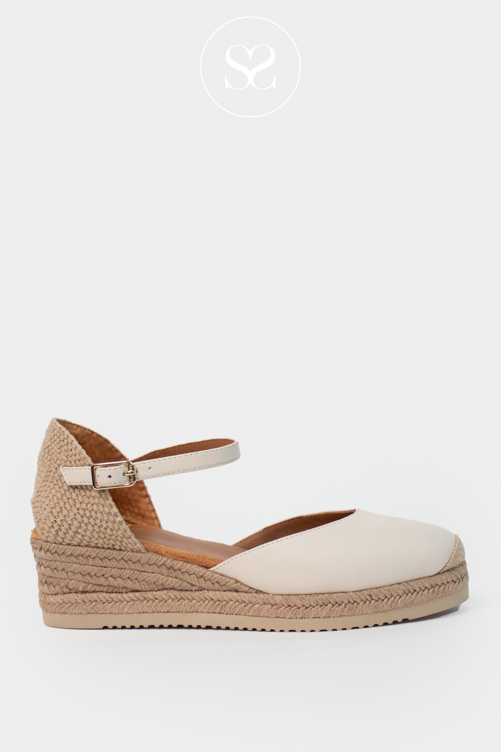 Unisa caceres off white low wedge espadrille sandals. Closed round toe with platform sole, elevated wedge and adjustable ankle strap.