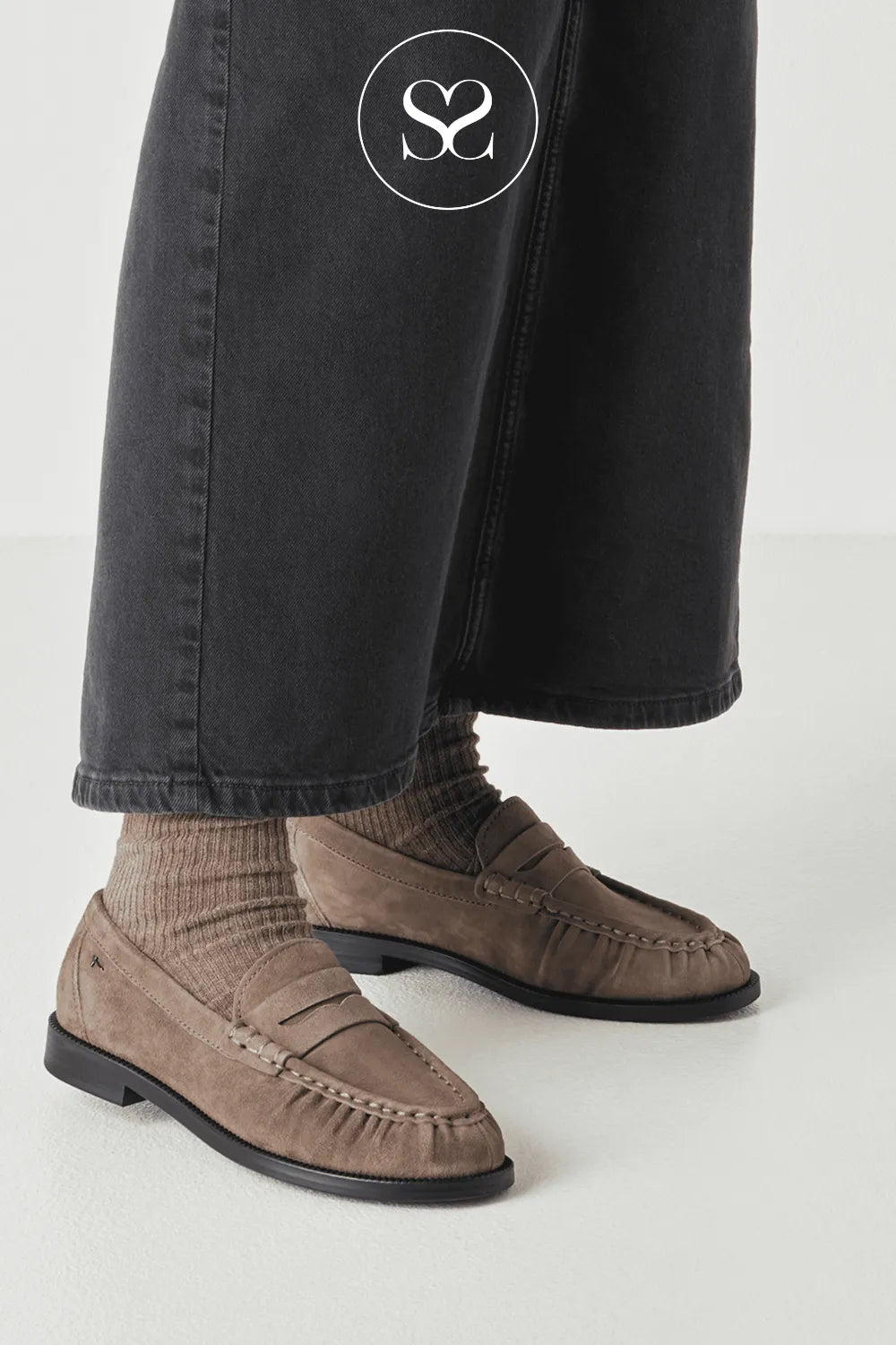 Taupe suede slip on shoe. Flat shoe in a neutral colour. Boat shoe ruching on the toe.