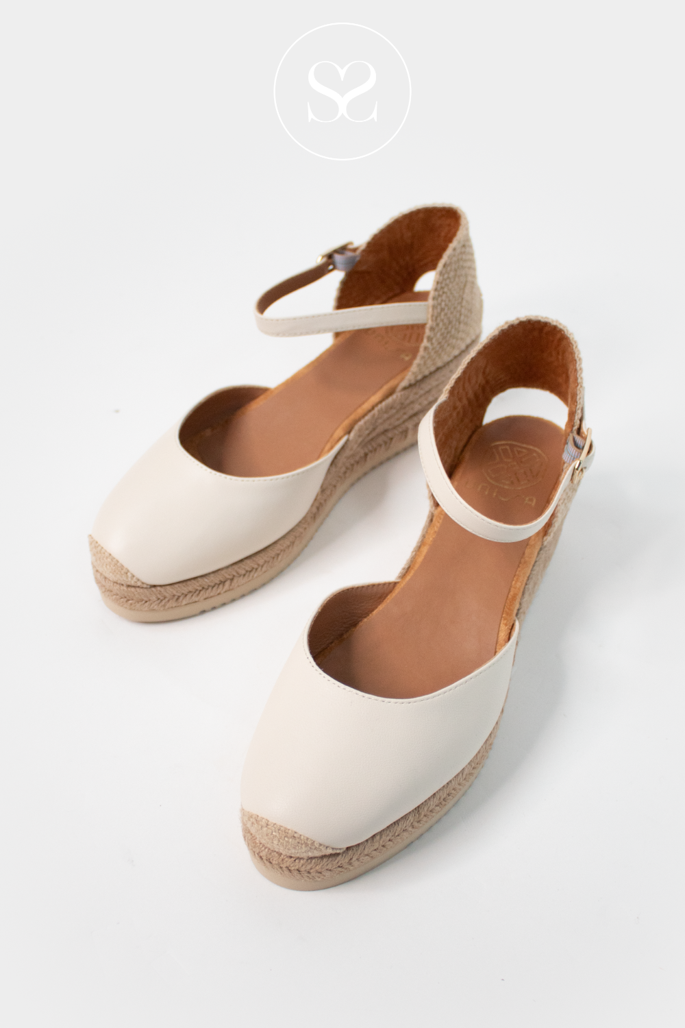 Unisa spanish leather wedge espadrille sandals. Off white round toe wedges. Adjustable ankle strap. Low wedge. Low heel sandals. Woven fabric heel.