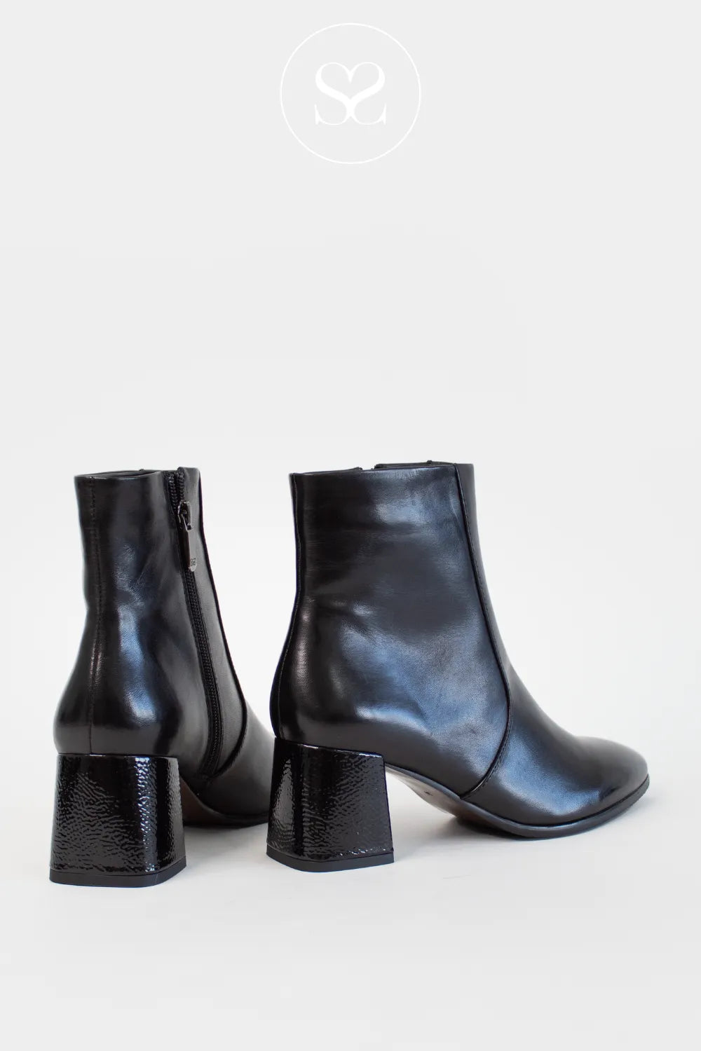 Pair of black leather ankle boots on a white background