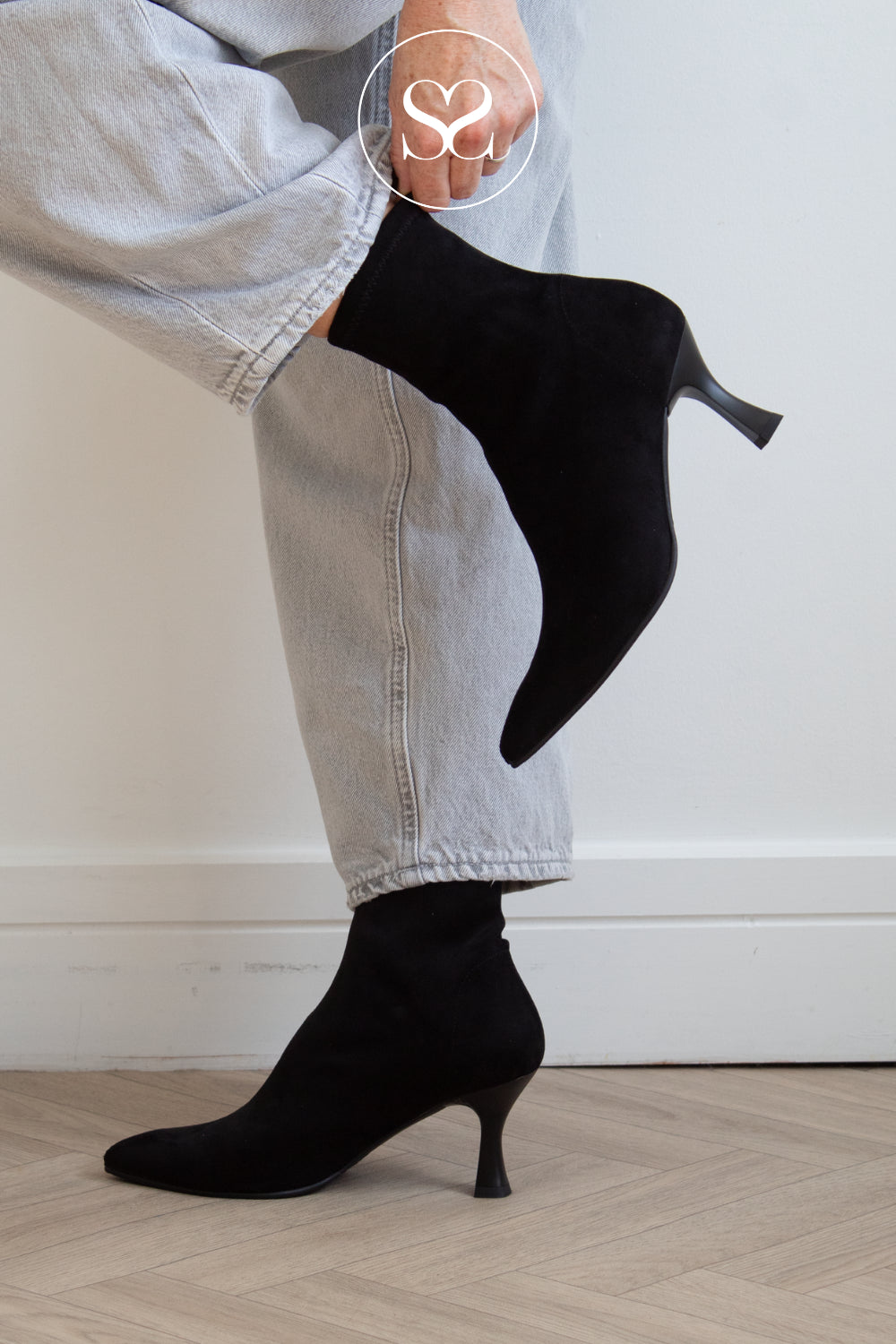 MOdel Wearing black suede sock boots with pointed toe and kitten heel from Miss Elastic