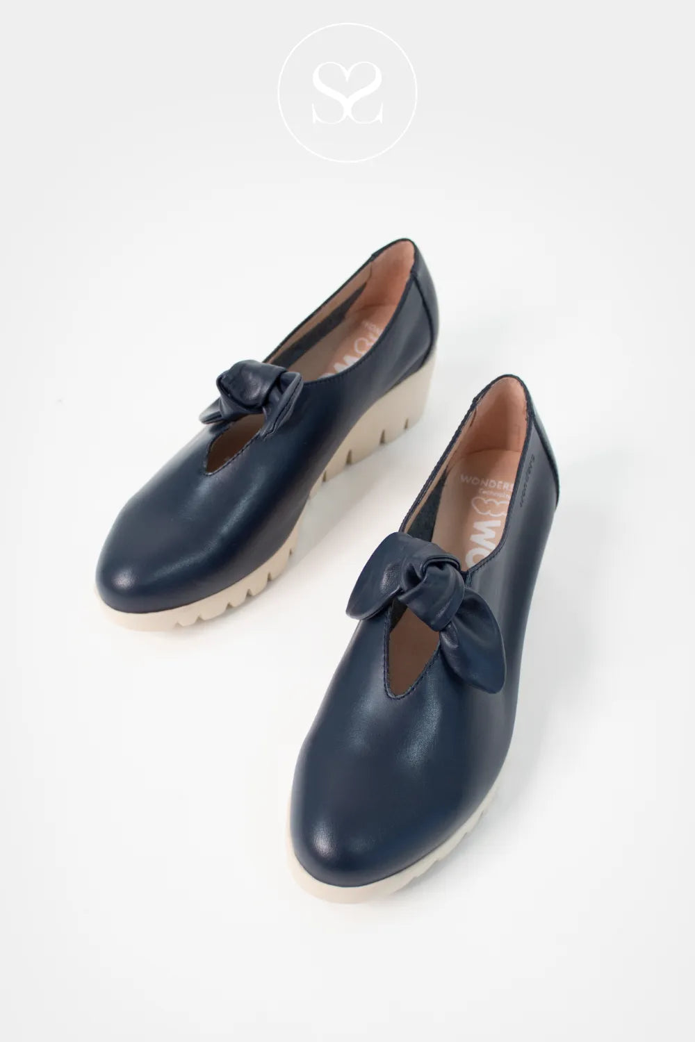 Wonders Navy Wedge Slip-On Shoes C-33159 Neat knot bow detail giving a subtle, feminine touch.