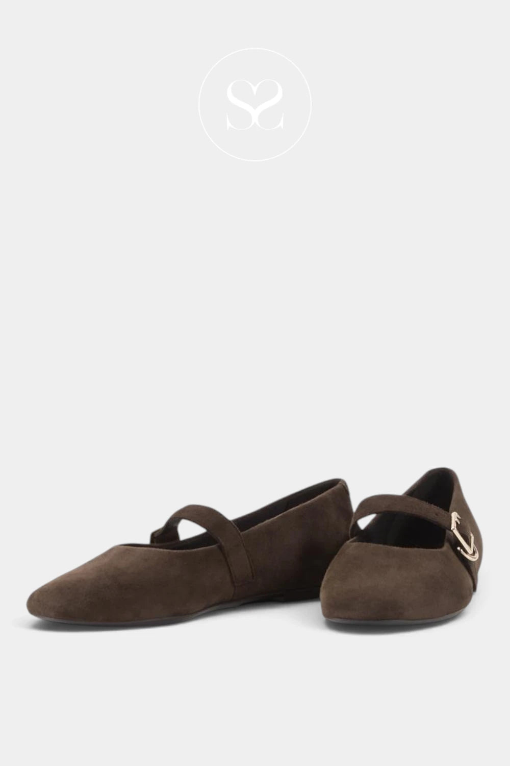 A pair of dark brown suede ballet flats with a strap across the instep and a small gold buckle detail on one shoe, displayed against a light gray background.
