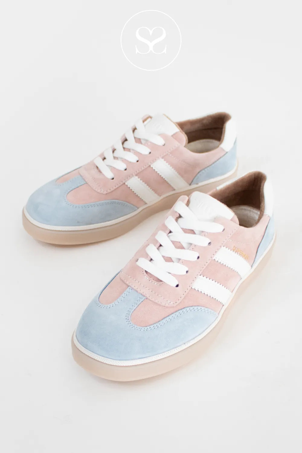 Pair of pastel pink and blue sneakers with white laces. Summer sneakers. Affordable trainers