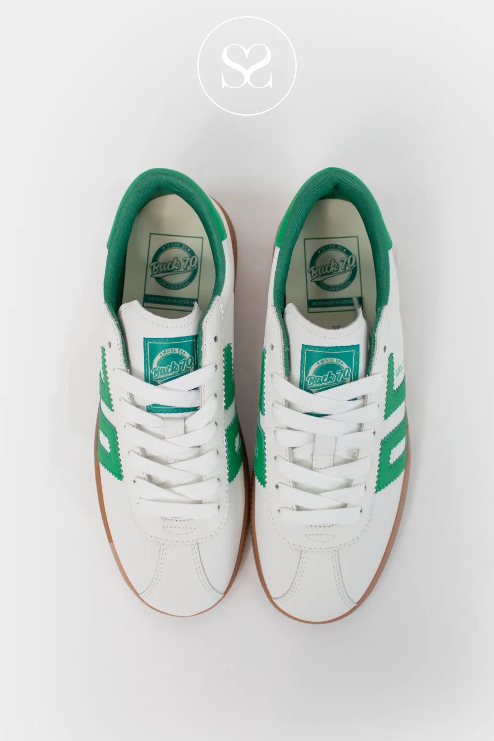 Back 70 white leather flat slimline trainers with green logo and heel cap. Lace up trainers and gum sole. Retro style everyday sneakers.