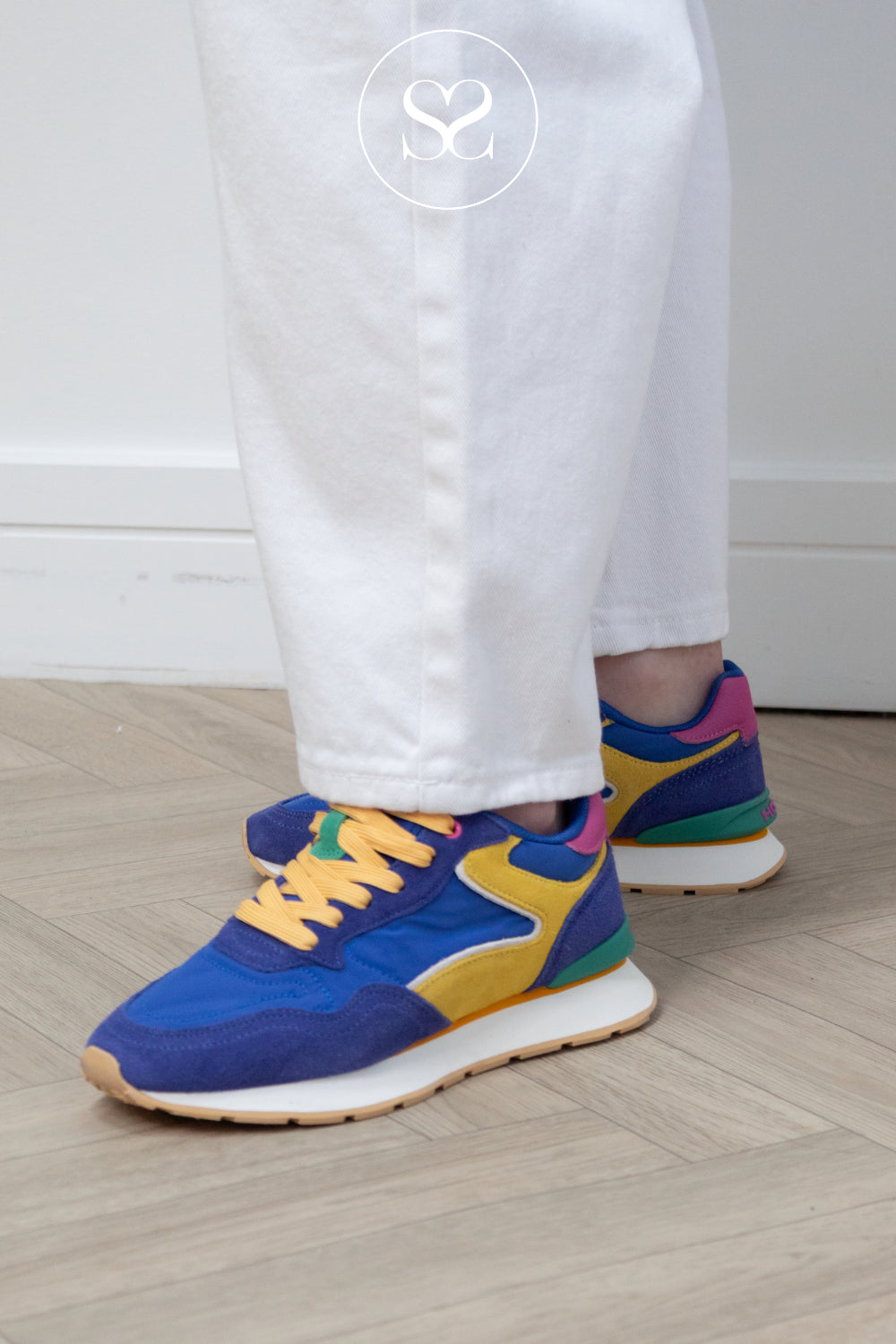 Woman wearing blue hoff sneakers - dopamine