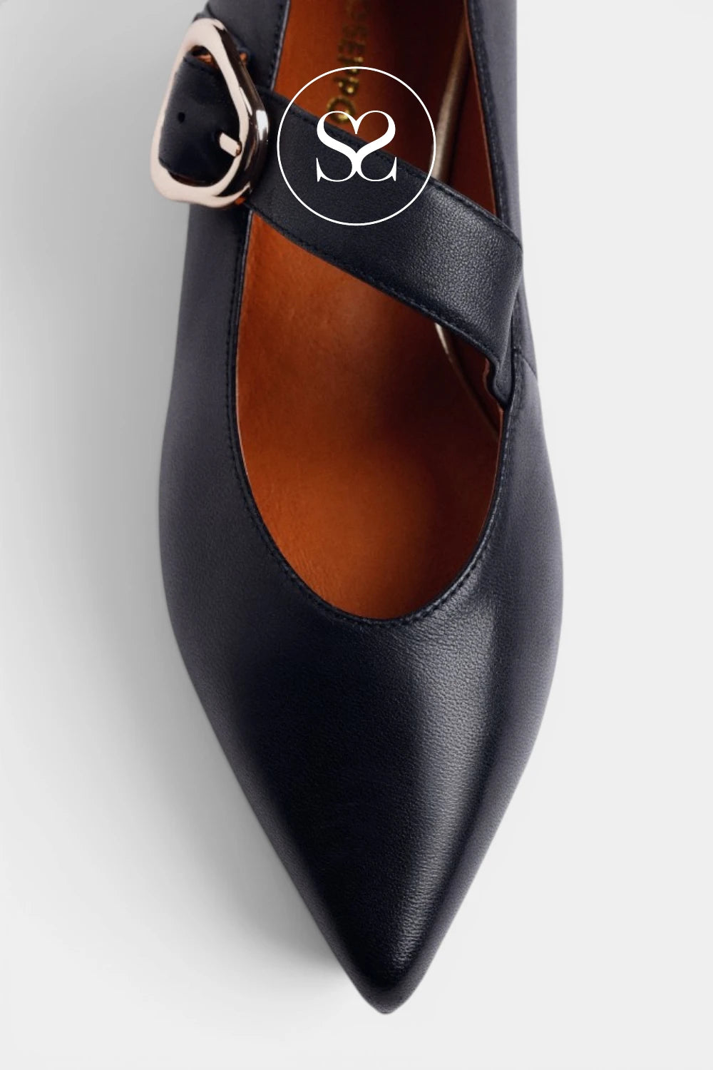 A close-up of a black pointed-toe Mary Jane pump with a silver-tone buckle strap, shown on a light gray background with a circular 'S2' watermark overlay.