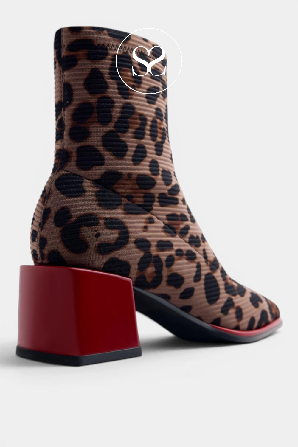 A leopard print ankle boot with a chunky red block heel, shown from a three-quarter rear angle on a light gray background.