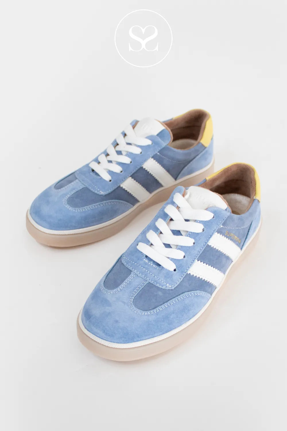Pair of blue trainers with white laces.