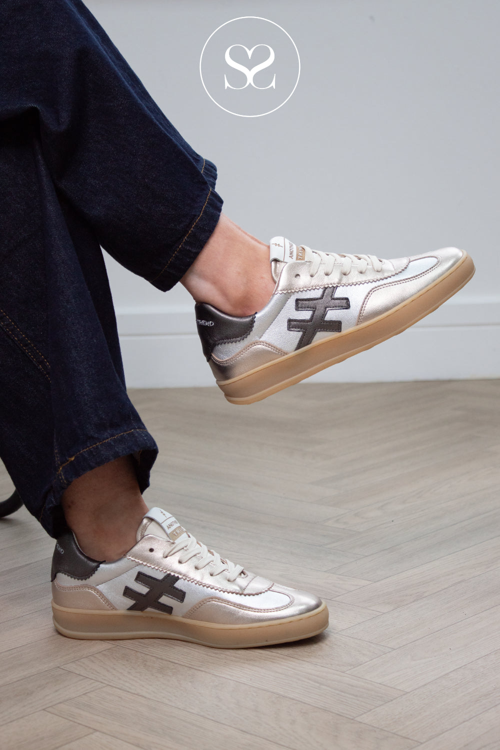 Woman wearing silver metallic trainers that are dressy and comfortable