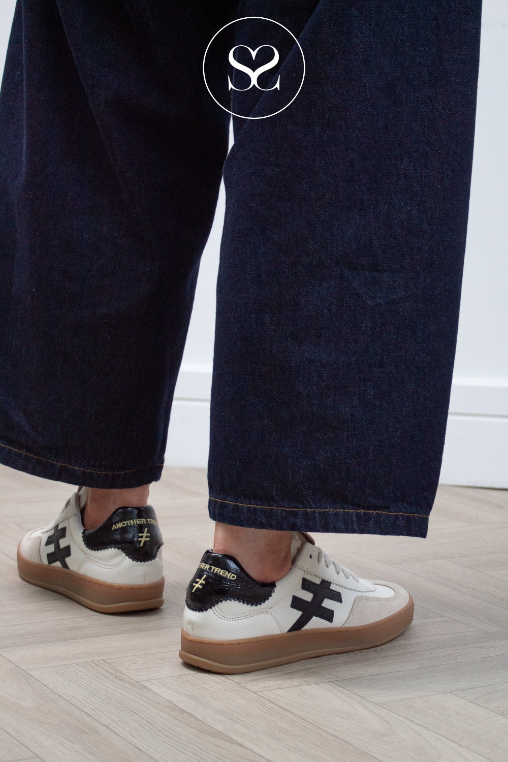 Woman wearing brown and Off white trainers from Another trend in Ireland