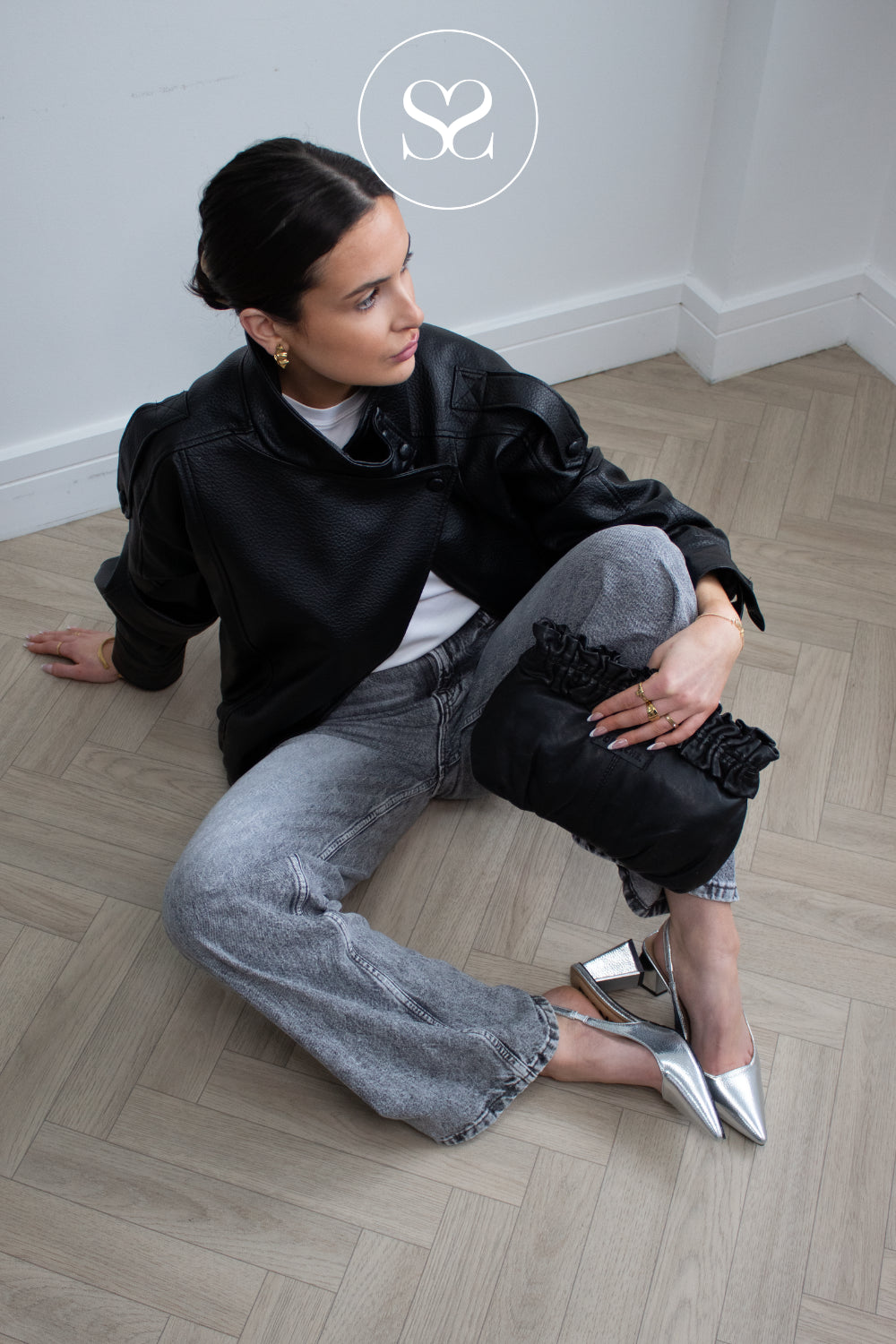 woman wearing silver pointed toe sling backs with block heel from Bianco