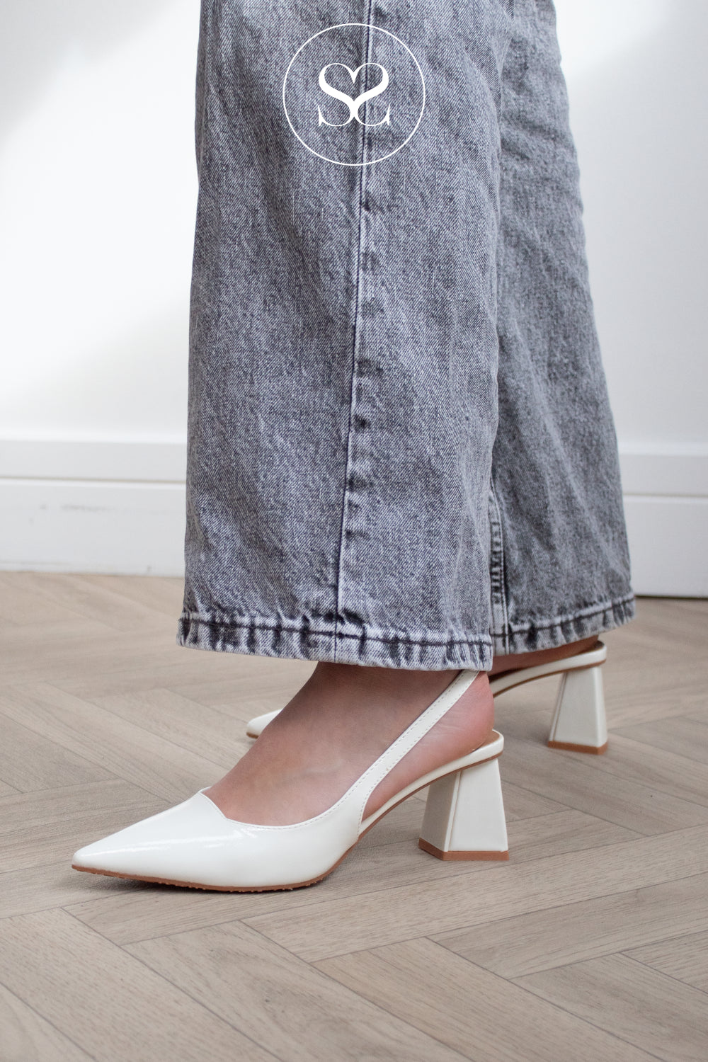 woman wearing off white pointed toe slingbacks with high heel from Bianco