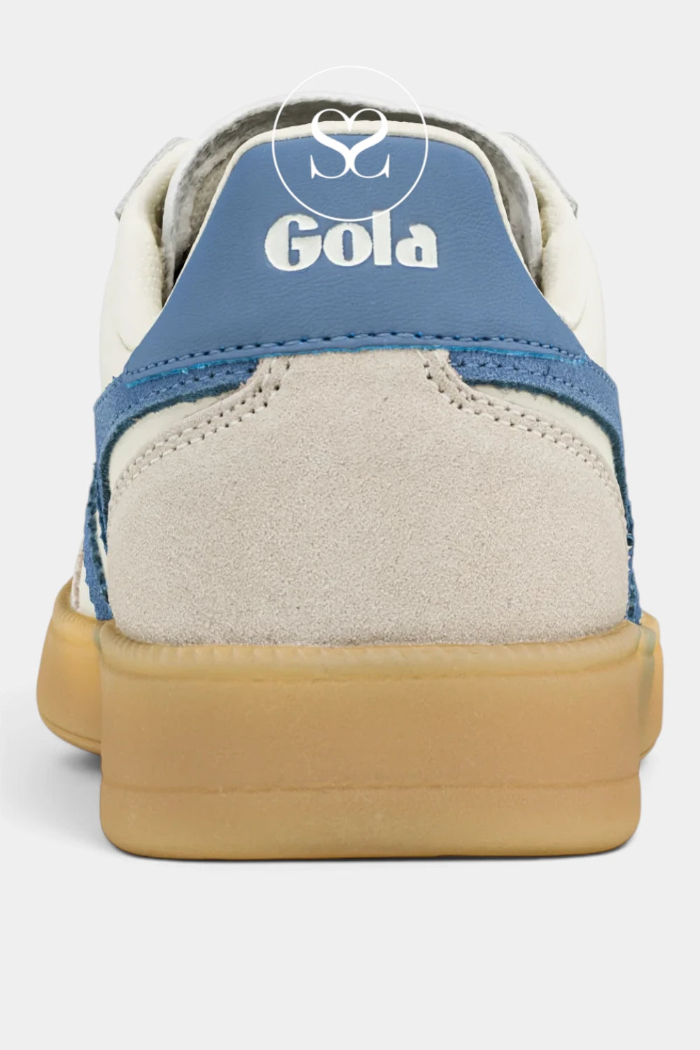 A close-up rear view of a Gola sneaker featuring a cream suede upper, a blue leather heel tab with white branding, and a thick tan gum rubber sole, set against a light gray background.
