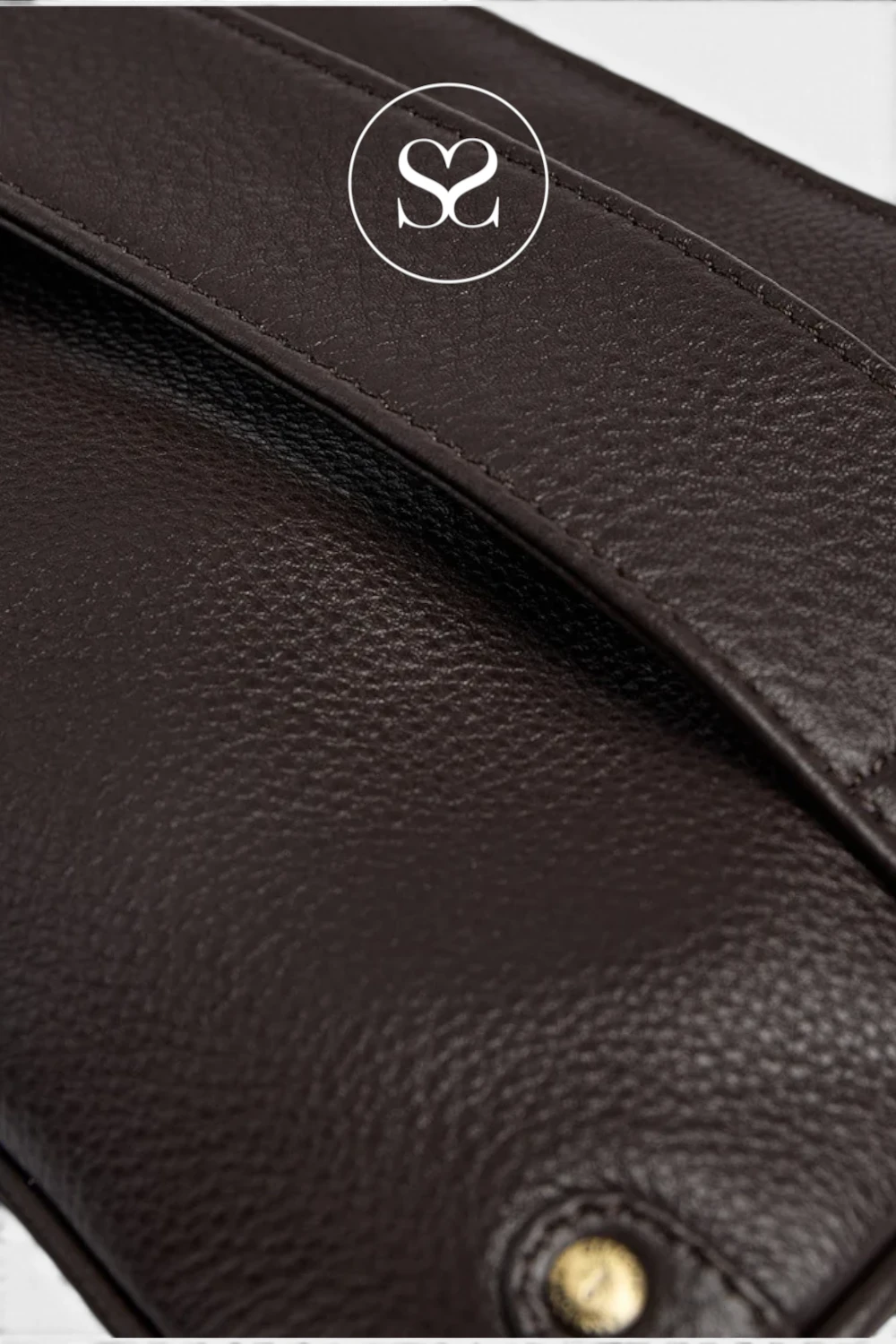 Close-up of a dark brown pebbled leather bag with a gold-tone snap button and a white circular logo overlay featuring an 'S' monogram.